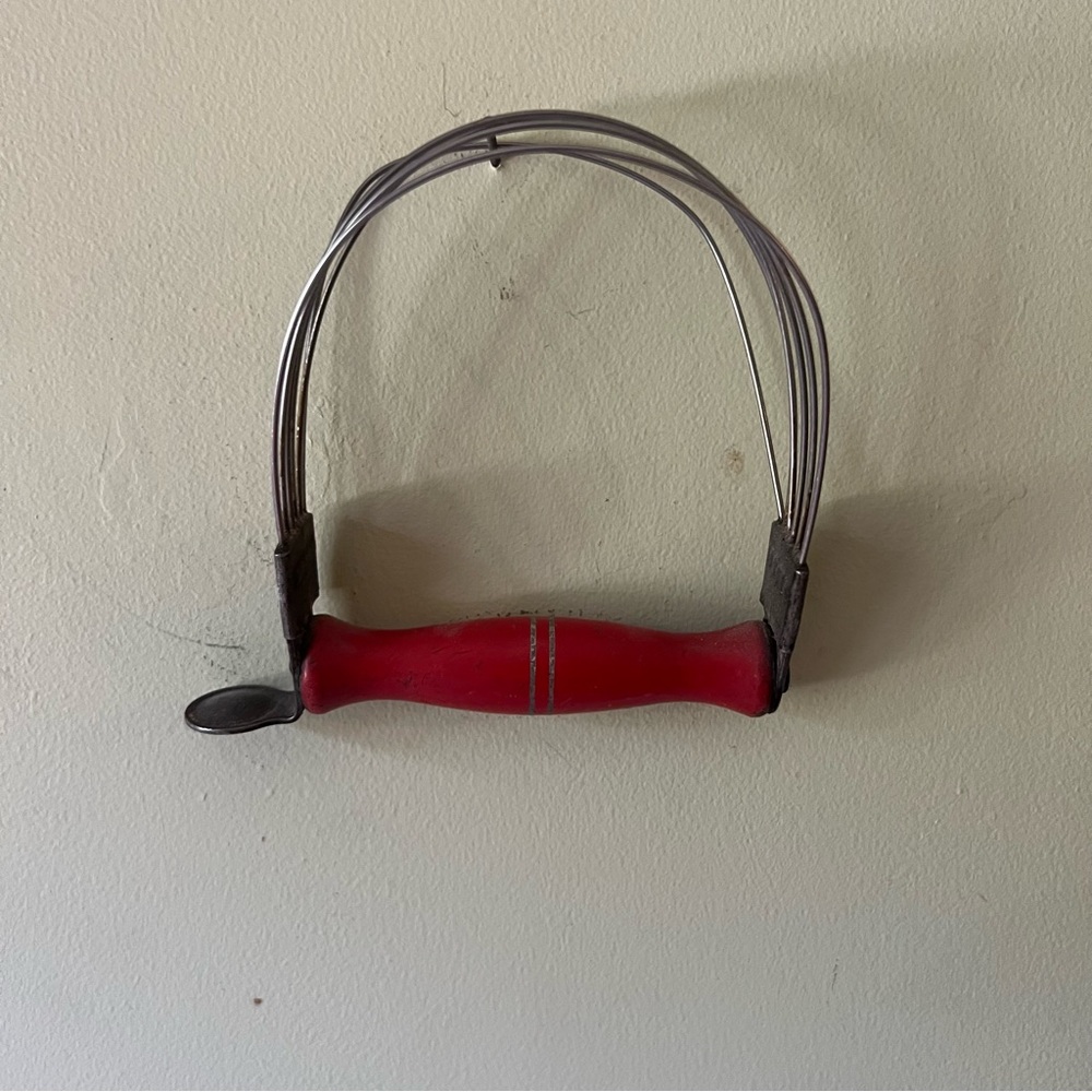 Antique hand dough mixer with wooden handle.